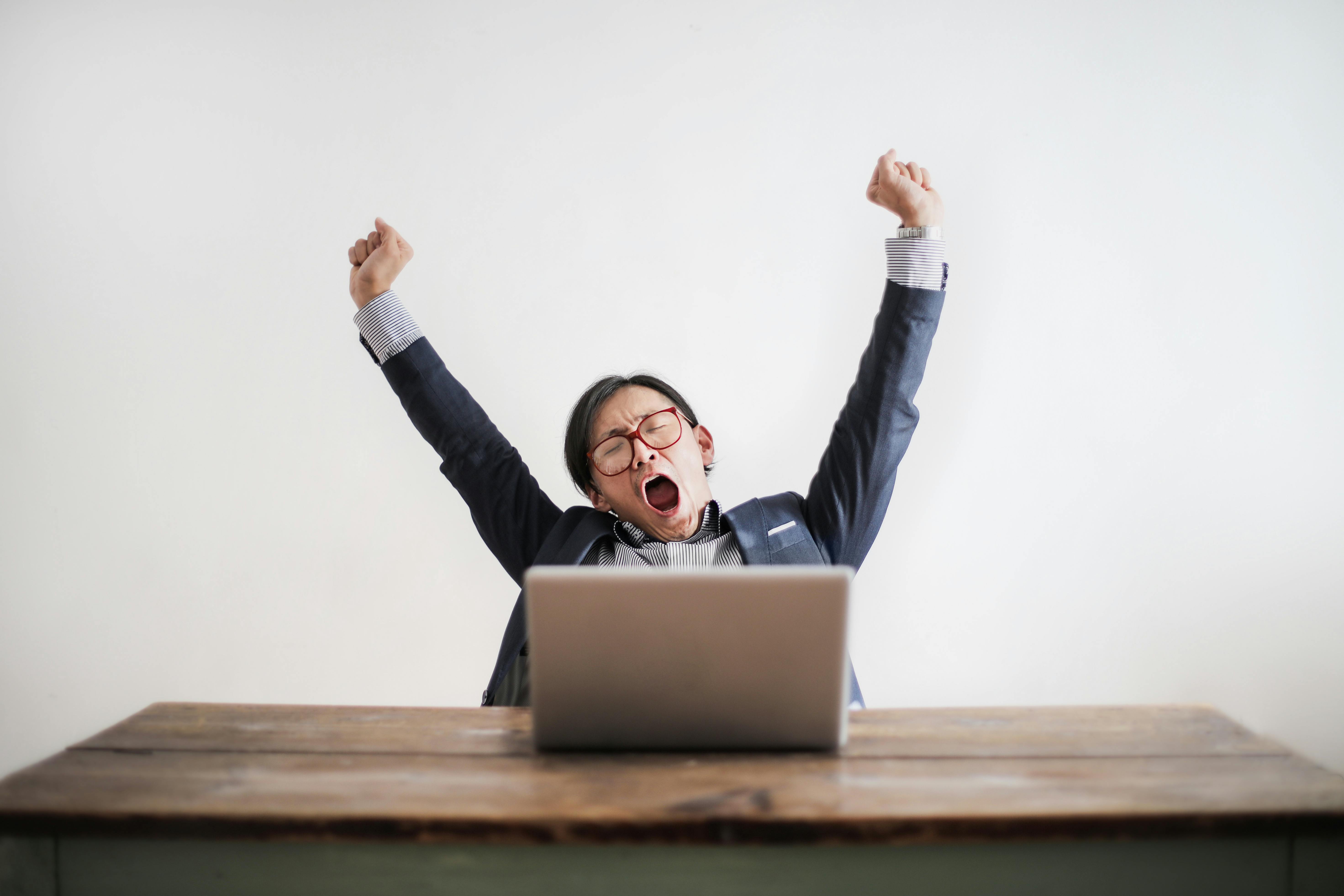 Man yawning at desk - repetitive work
